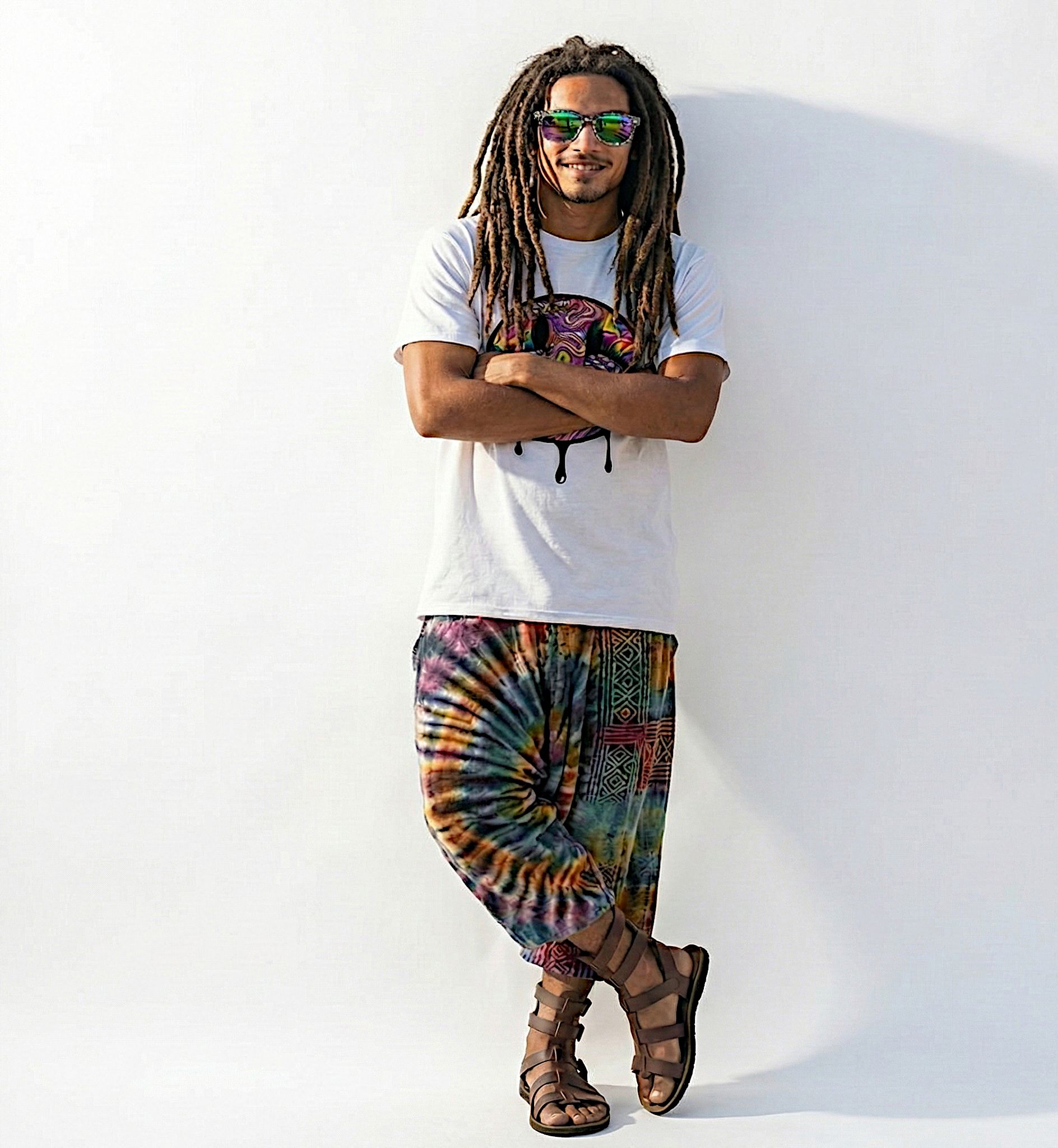 A photo of Mana wearing the melting smiley acid tee with arms crossed