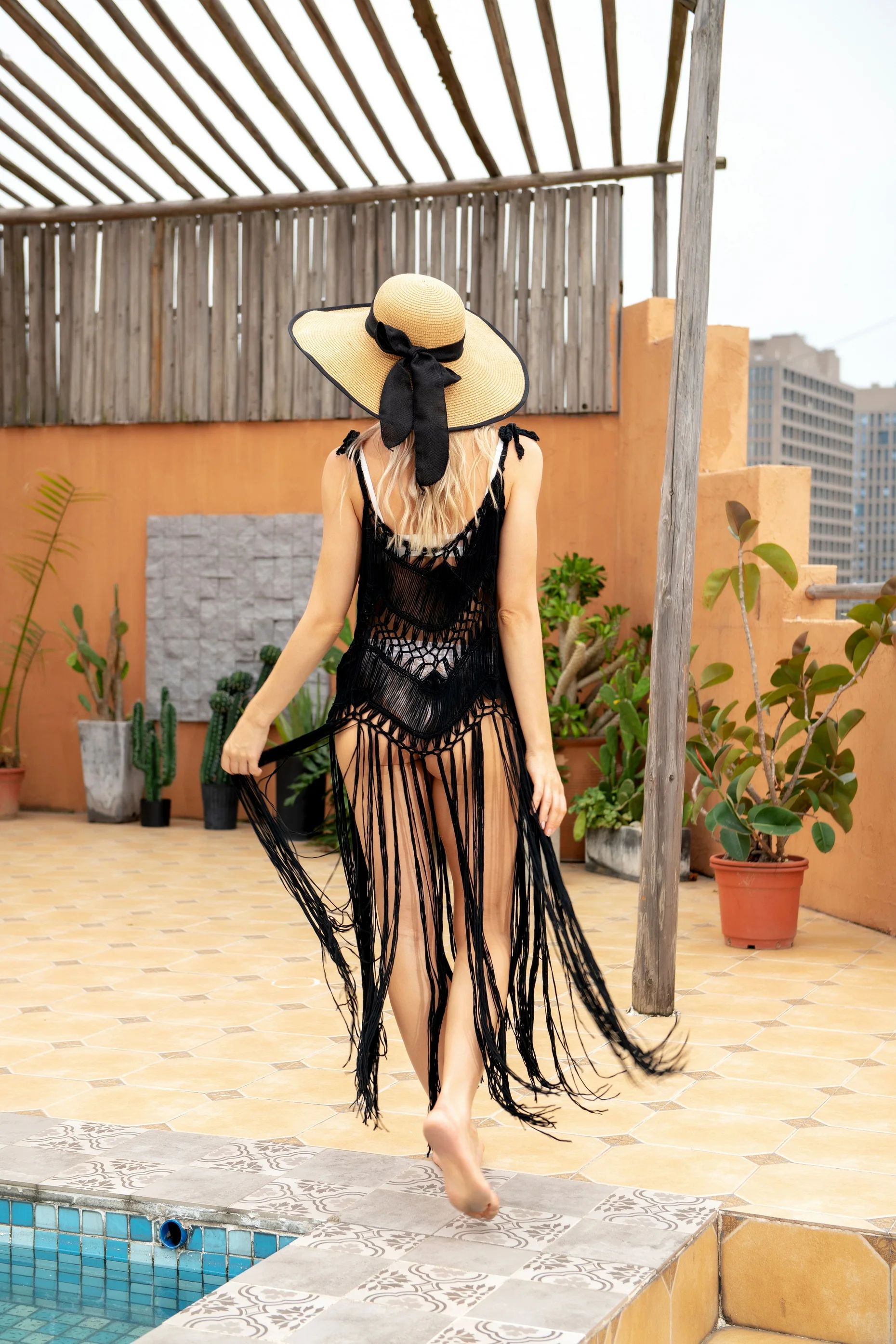 Action shot of the tassels moving on the black dress | Ravers Co