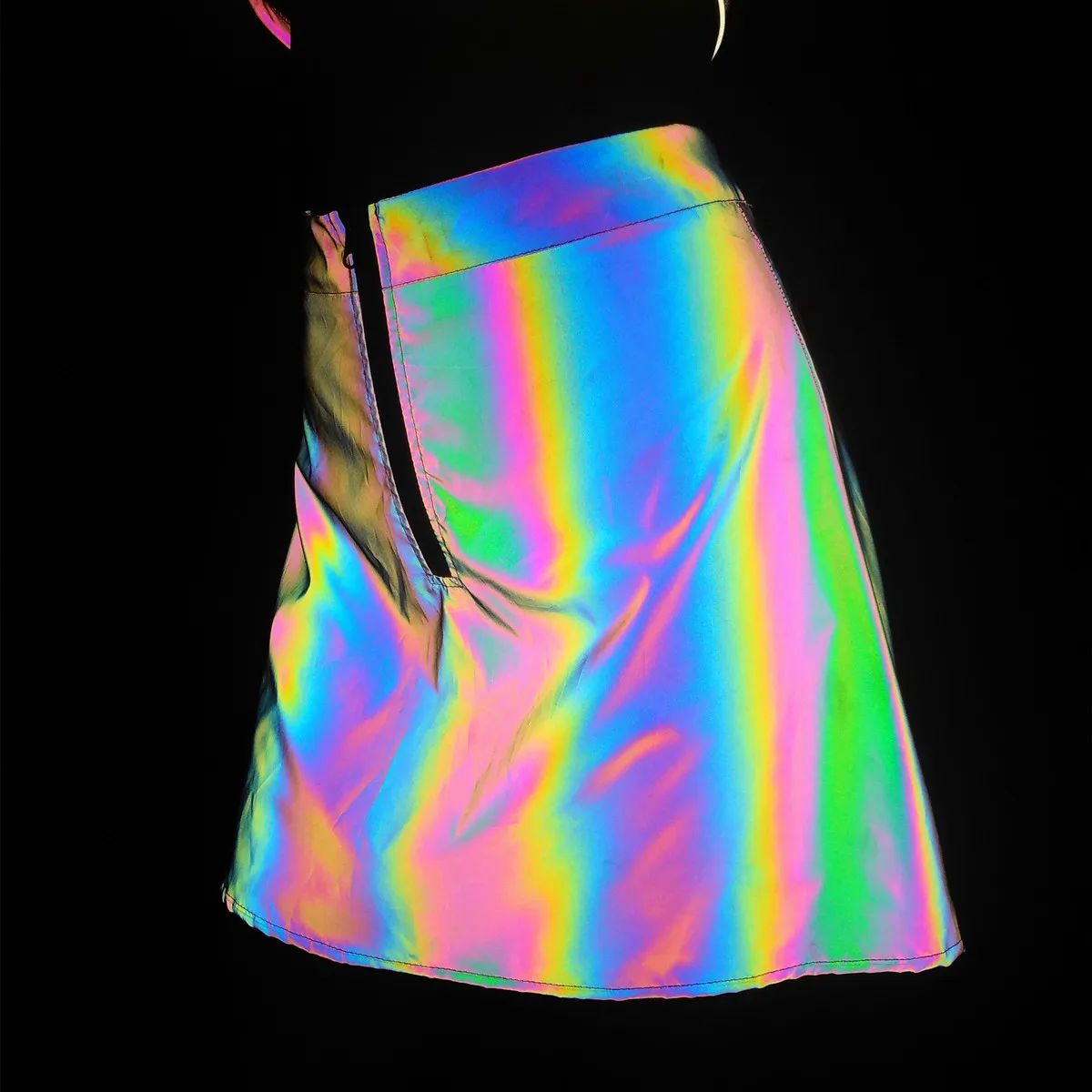 Reflective Rainbow Raving Set 10 Side view of model wearing the rainbow rave skirt under flash | Ravers Co