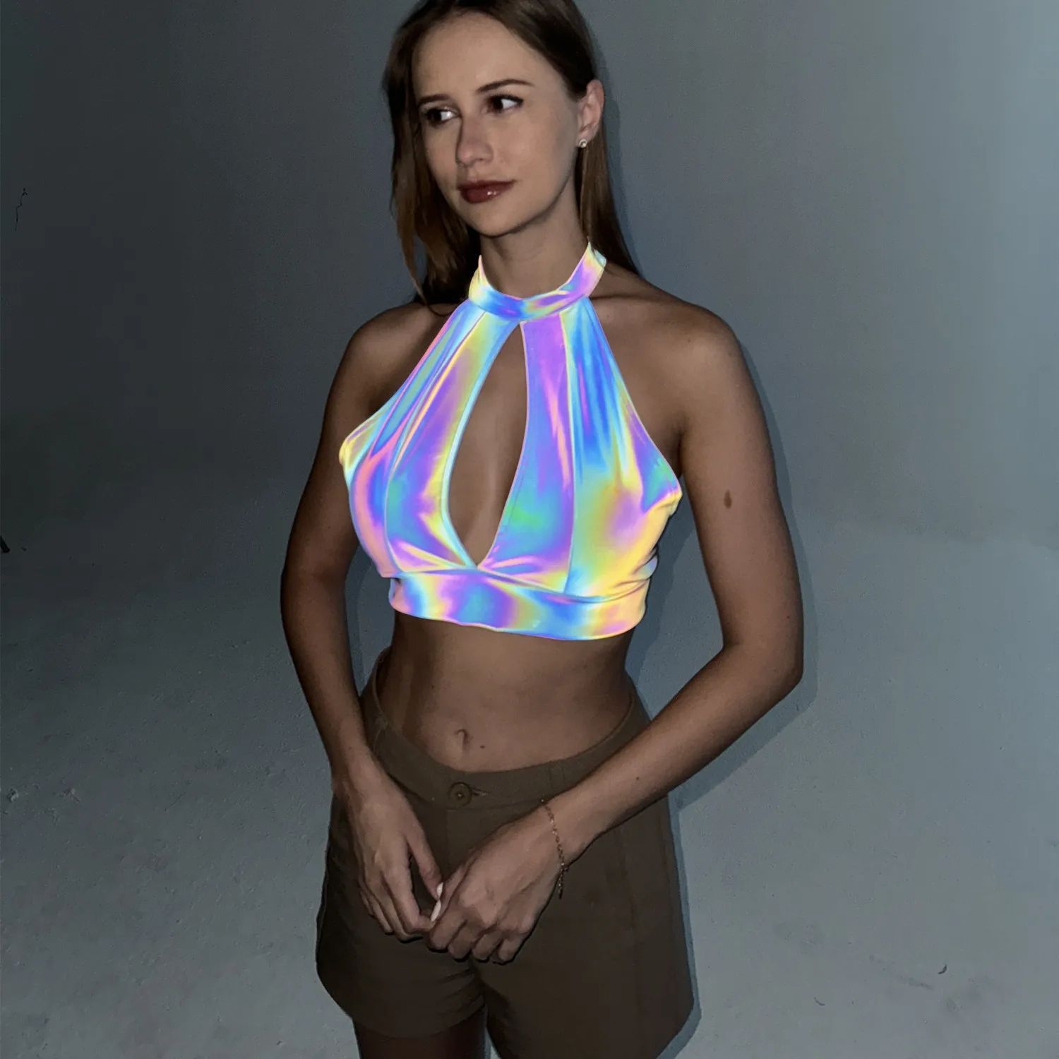 Reflective Laser Halter Crop 8 A photo of a model wearing the Reflective Laser Halter Crop flash lights