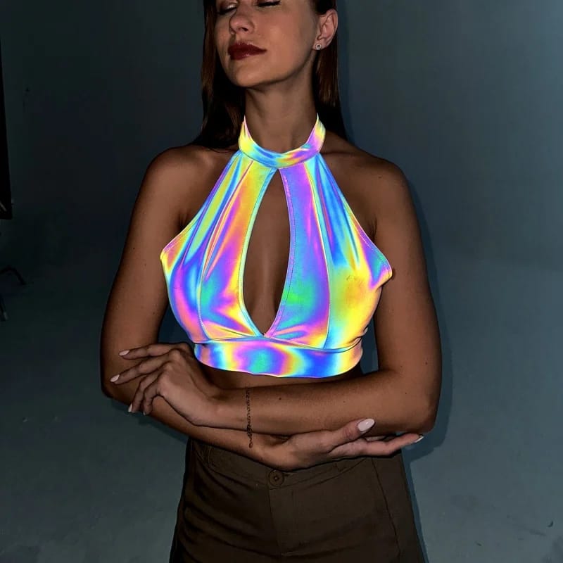 Reflective Laser Halter Crop 9 A photo of a model wearing the relfestive laser halter crop with arms folded under flash lights