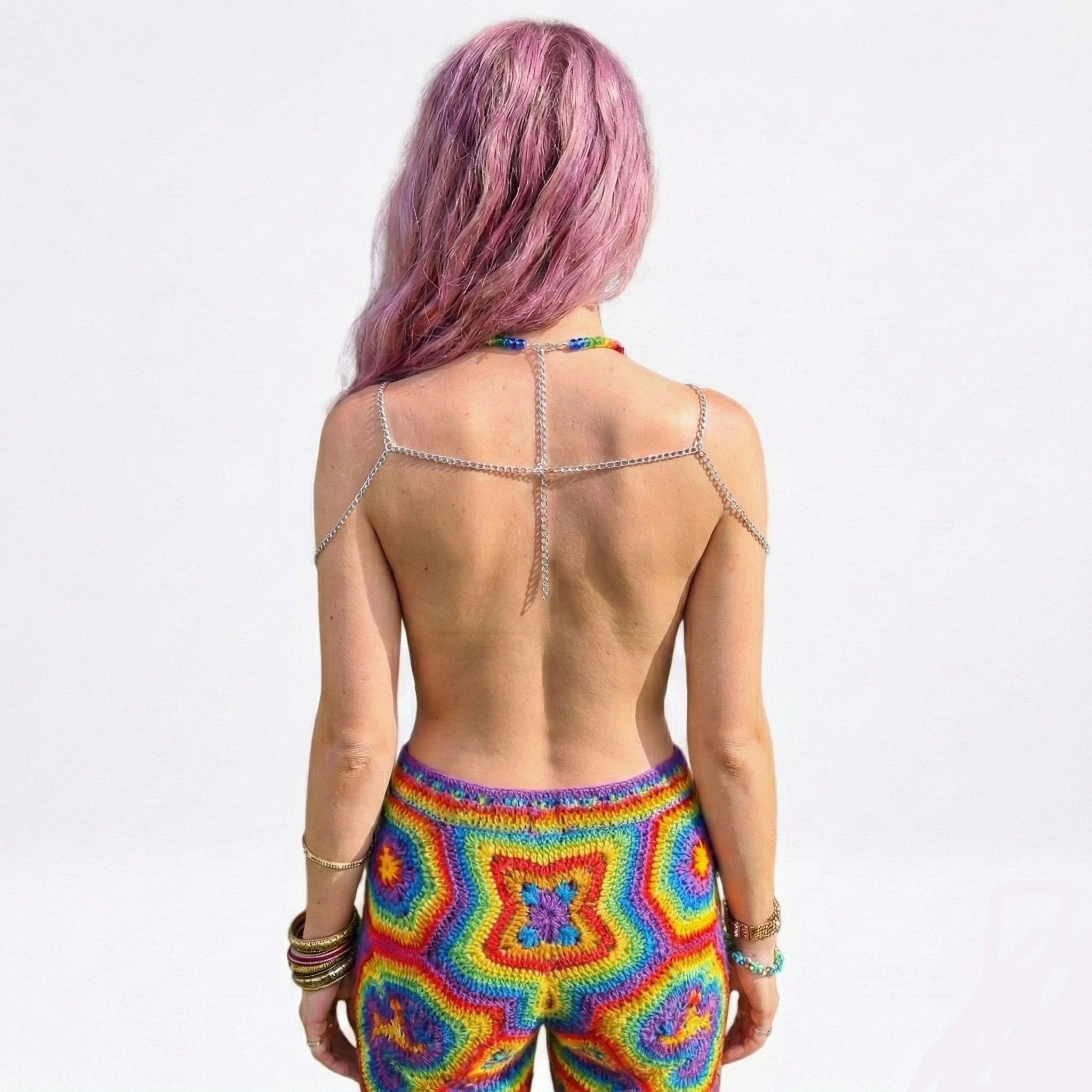 Rainbow Bead Chain Top 3 A photo of Laura, with back to camera, wearing the Rainbow Bead Chain Top and other trippy festival clothing.