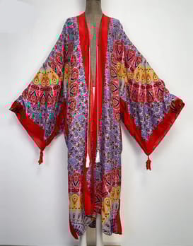 Wide shot of the red eye rave kaftan on a mannequin