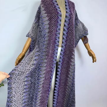 Trippy Crochet Poncho Cloak in Gold Blue Teal on a model | Ravers Co