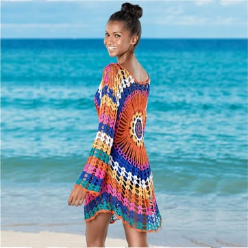 Crochet Rainbow Flower Dress - model wearing at the beach | Ravers Co