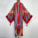 Wide shot of the red eye rave kaftan on a mannequin
