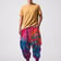 Michael is wearing the Liquid Frequency Shroom Pants