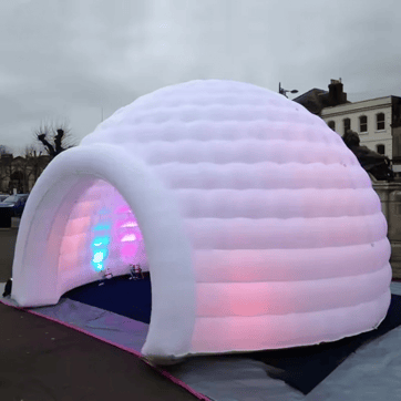 Giant Inflatable LED Festival Igloo lit up at dusk | Ravers Co