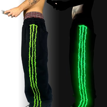 Man wearing Glow Stripe Rave Pants from a side angle at a festival | Ravers Co