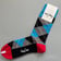 Red & Blue Colourful Happy Rave Socks laid flat showing thick cotton texture | Ravers Co