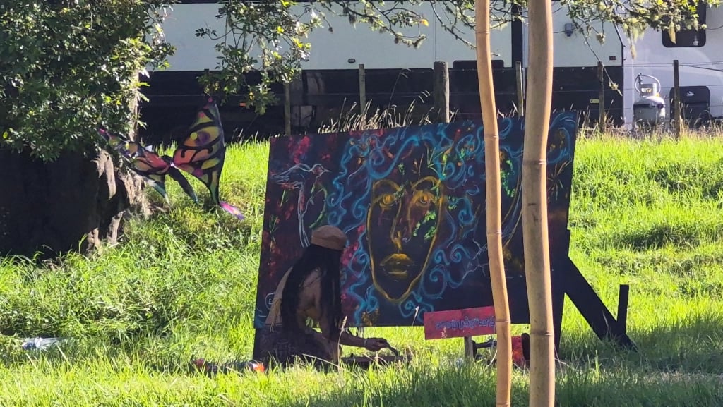 A photo of a live painter at dimension Architects of the portal: Crafting The Festival Flow