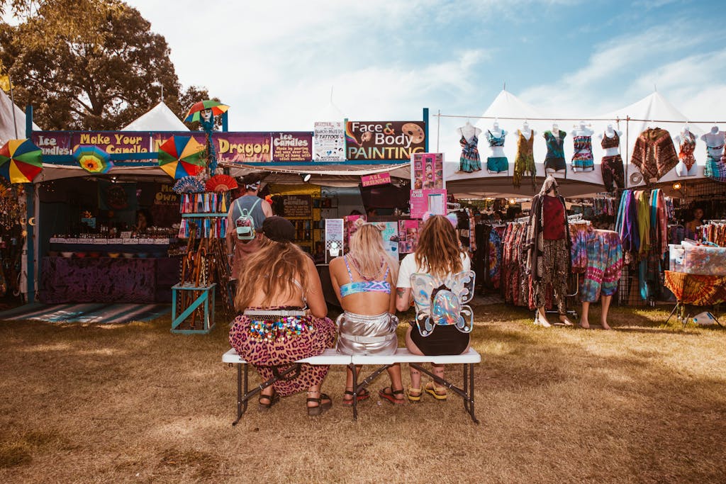 Photo by Wendy Wei Bright festival scene featuring women dressed in ravewear