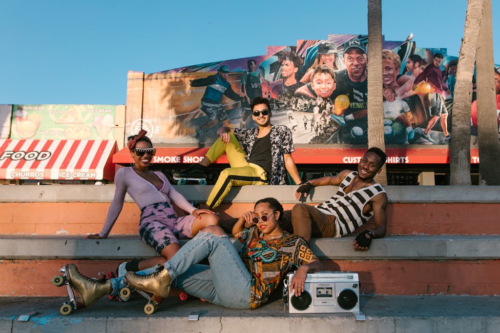 Photo by RDNE Stock project Group of diverse friends enjoying a sunny day with roller skates and a boombox. PLUR