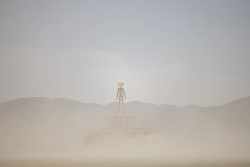 Photo by Stephen Leonardi The famous Burning Man statue enveloped in desert sands and mist during the festival.